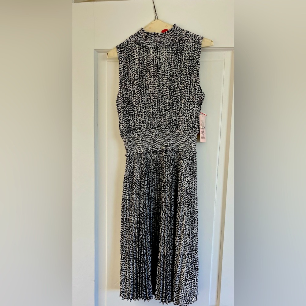 Nanette black, white, and grey sleeveless pleated dress with mock turtleneck.